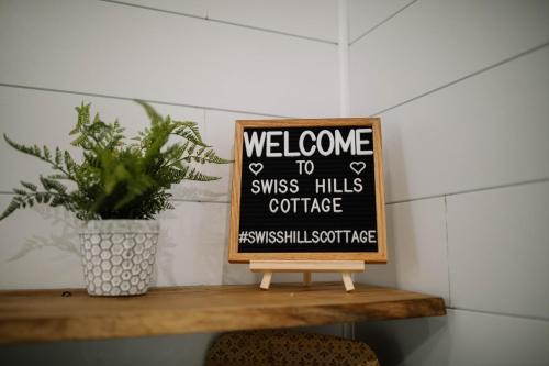 a sign that says welcome to swiss hills coffee at Cozy Cottage on 250 Acre Dairy Farm Near Ark in Dry Ridge