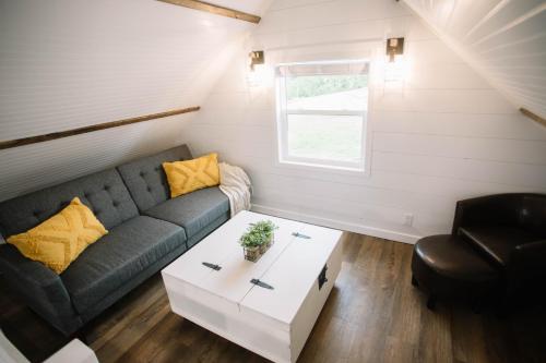 a living room with a couch and a table at Cozy Cottage on 250 Acre Dairy Farm Near Ark in Dry Ridge