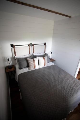 a bedroom with a large bed with pillows at Cozy Cottage on 250 Acre Dairy Farm Near Ark in Dry Ridge