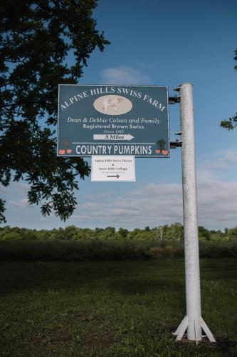 a sign on a pole in the middle of a field at Cozy Cottage on 250 Acre Dairy Farm Near Ark in Dry Ridge