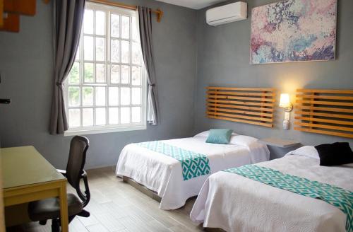 Un ou plusieurs lits dans un hébergement de l'établissement Vf Hotel