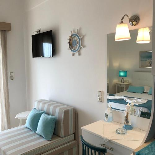 a room with two beds and a mirror at Spyridonou House in Parga