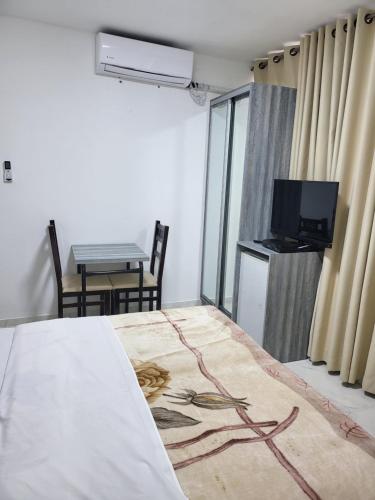 a room with a bed and a table and a tv at J-MOTEL in Jerusalem