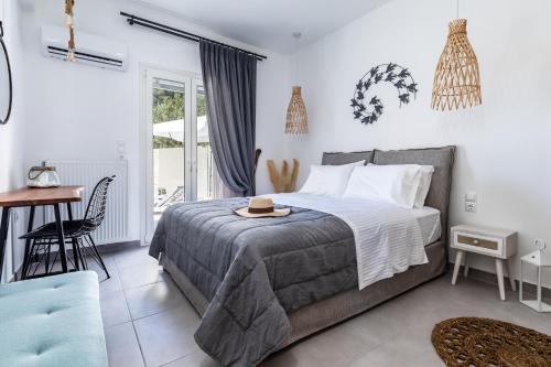 a bedroom with a bed with a hat on top of it at Ninemia Villa in Skopelos in Skopelos Town