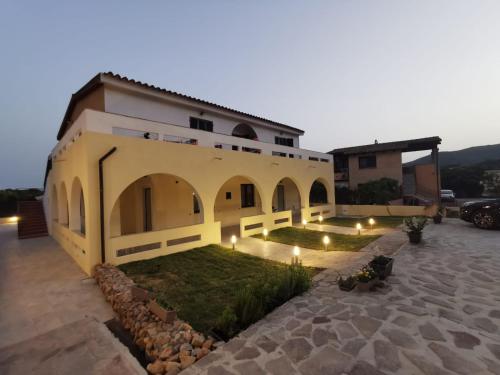 a house with a courtyard with lights in front of it at Villa Bianca in Chia