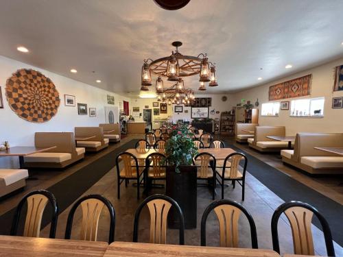 a restaurant with tables and chairs and a chandelier at Border Inn Casino in Baker