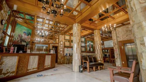 a room with columns and paintings on the walls at Hotel Marques Del Valle in Oaxaca City