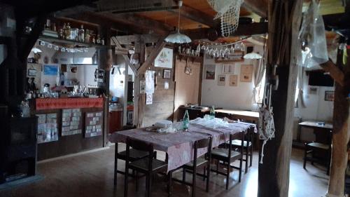 a dining room with a long table and chairs at Rooms Ma La in Karlovac