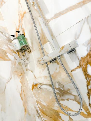 a water hose hooked up to a ceiling at Ashfield Boutique Stays in Altrincham
