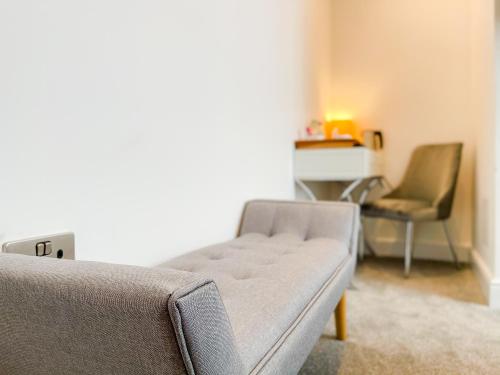 a living room with a couch and a chair at Ashfield Boutique Stays in Altrincham