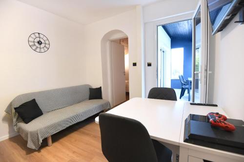 a living room with a table and a couch at Apartment by the sea Renata in Punta Skala in Petrcane