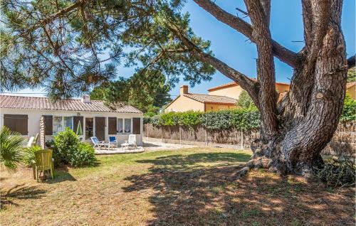 ein Haus mit einem Baum im Hof in der Unterkunft Holiday Home Les Moutiers En Retz Rue De Bois Millet in Les Moutiers