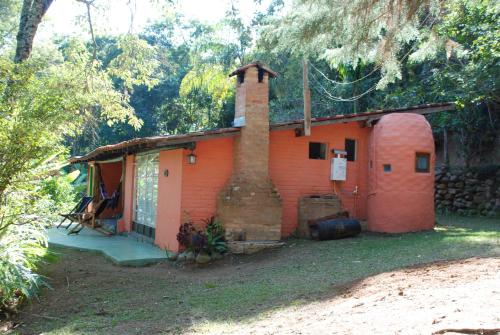 a small brick house with a brick chimney on it at Pousada Estância Rio Acima in Itamonte