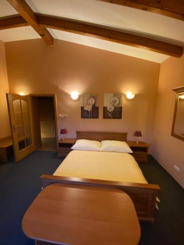 a bedroom with two beds and two tables and lamps at Selský Dvůr Perštejn in Pürstein