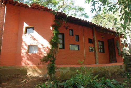 a house with an orange brick at Pousada Estância Rio Acima in Itamonte