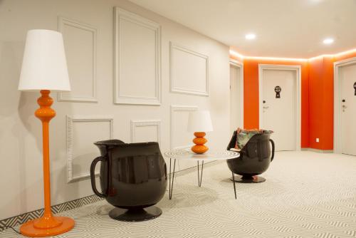 a living room with two chairs and a lamp at Ibis Styles Wroclaw Centrum in Wrocław