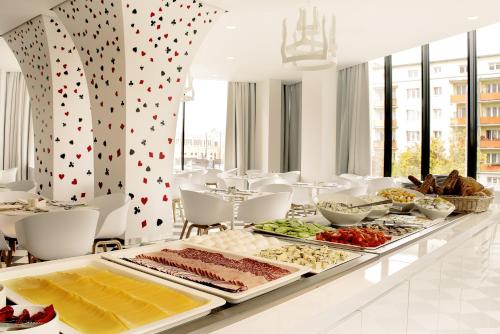 a buffet of food on a table in a restaurant at Ibis Styles Wroclaw Centrum in Wrocław