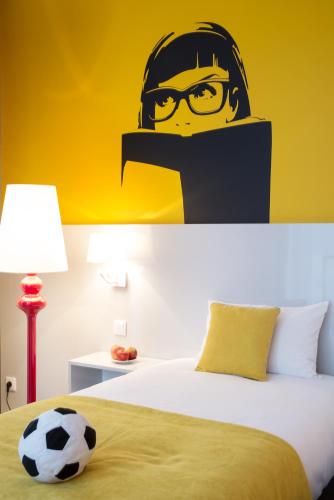 a bedroom with a bed with a helmet and glasses at Ibis Styles Wroclaw Centrum in Wrocław