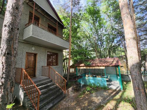 a house with a balcony and a swimming pool at King in Tsaghkadzor