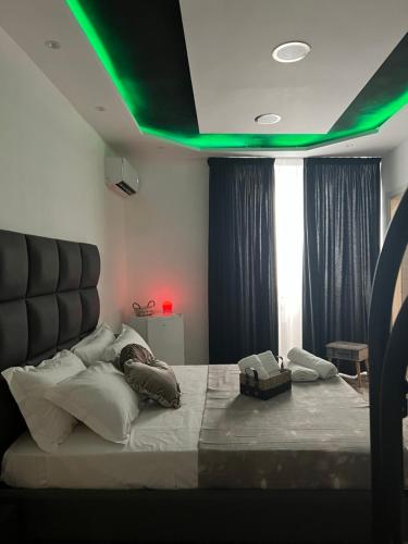 a bedroom with a large bed with green lighting at Dream & Fly in Naples