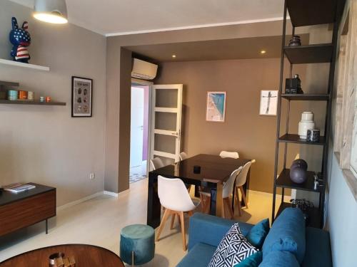 - un salon avec un canapé bleu et une table dans l'établissement SoNiceRiviera, à Nice