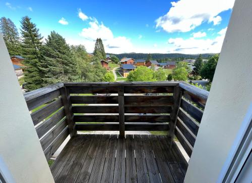 a balcony with a view of a city at Appartement lumineux avec piscine chauffée en saison in Saint-Laurent-du-Jura