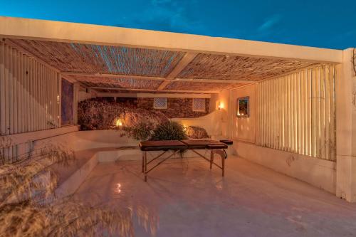an outdoor patio with a table on a building at On The Rocks Antiparos in Antiparos Town