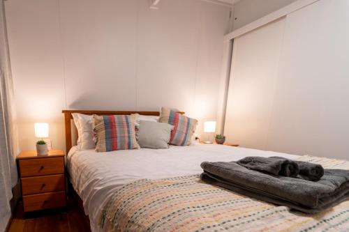 a bed with a blanket on it in a bedroom at The View, Metung in Metung