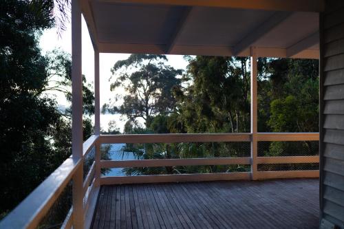 a porch of a house with a view of the water at The View, Metung in Metung