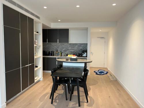 a kitchen with a table and chairs in a room at WSP luxury 2b2b apartment in CBD with free parking in Melbourne