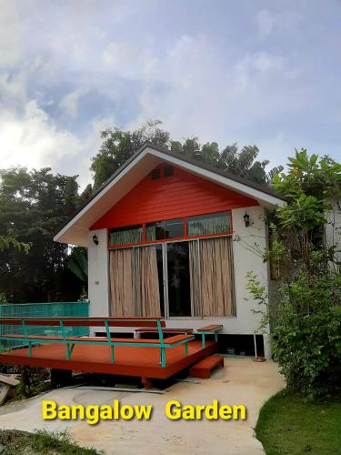 a small red and white house with a balcony at Korp View House in Wang Nam Khieo