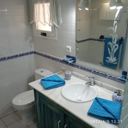 a bathroom with a sink and a toilet and a mirror at South facing Casa Bonnie in Playa Flamenca