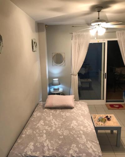 a bedroom with a bed and a table and a window at South facing Casa Bonnie in Playa Flamenca