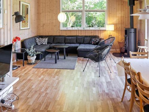 a living room with a couch and a table at 12 person holiday home in Hundested-By Traum in Hundested