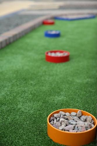 an orange bowl of rocks on the grass at Hotel Marusza in Grudziądz