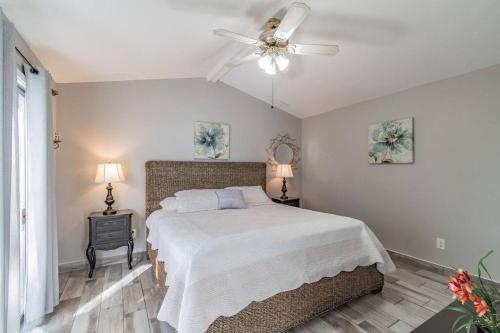 a bedroom with a bed and a ceiling fan at Bay Breeze Retreat plus 15 minutes from central TPA in Tampa