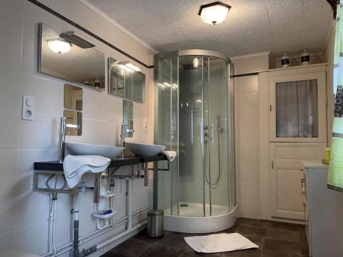 a bathroom with two sinks and a shower at Charmante maison familiale avec cour fermée, proche randonnées et sites naturels - FR-1-489-277 in Arfeuilles