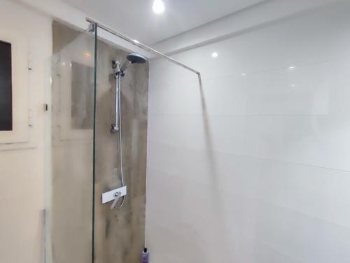 a shower with a glass door in a bathroom at Ideal Appart El Wahat VIP in El Aouina