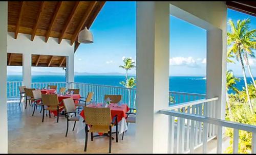 a dining room with a view of the ocean at Vista Mare Samana Amazing Views!! in Santa Bárbara de Samaná