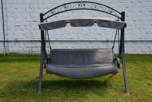 a swing chair sitting on the grass in a yard at Harmony Inn in Goderich