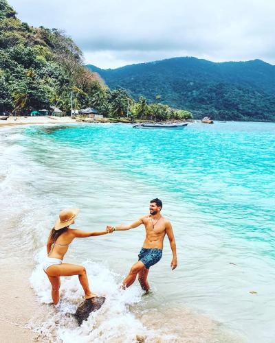 a man and a woman playing on the beach at Cabañas Luna Escondida in Capurganá
