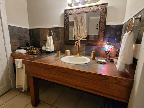 een badkamer met een wastafel en een spiegel bij MAGICAL MOROCCAN TENT WITH POOL CLOSE TO THE BEACH in Fort Pierce