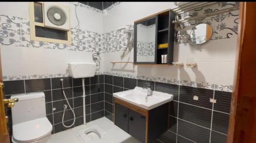 Baño pequeño con aseo y lavamanos en فندق ترند- trend hotel en Al Baha