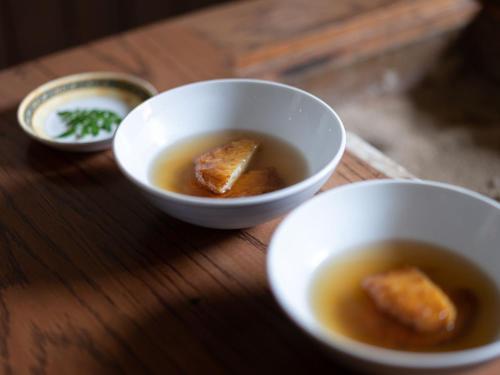 two bowls of soup on a wooden table at Nazuna Kyoto Nijo-jo in Kyoto