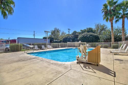a swimming pool with two lounge chairs next to it at Motel 6-Nogales, AZ - Mariposa Road in Nogales