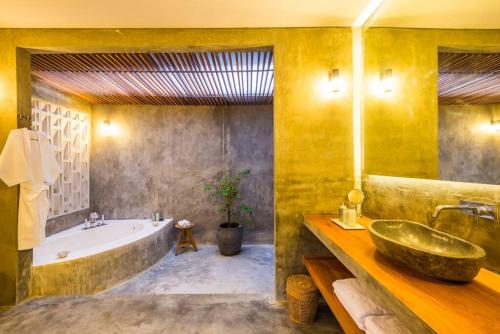 a bathroom with a large tub and a large sink at ROMANTIC - STYLISH - HIGH END 1BR VILLA in Canggu