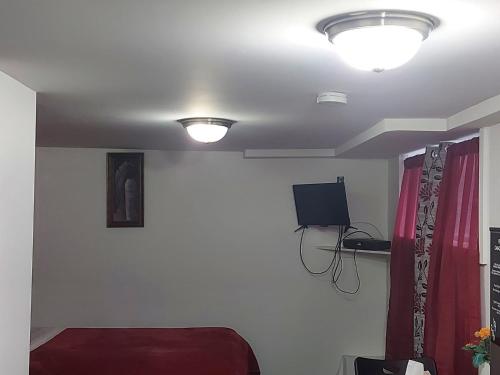 a room with a bed and a tv on the ceiling at Motel LA RÉFÉRENCE in Trois-Rivières