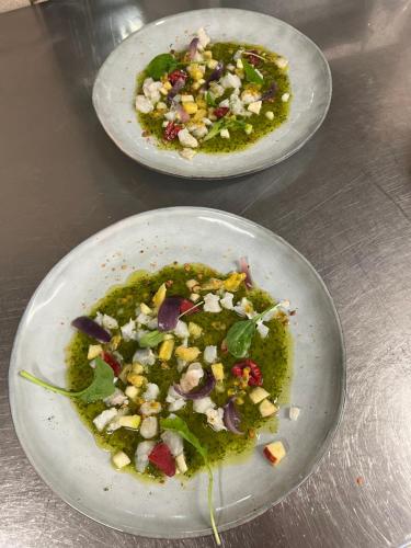 two plates of food sitting on a table at Hôtel Logis Restaurant La Fontaine in Mantry