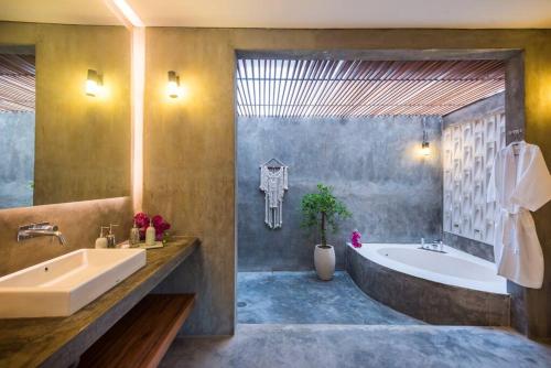 a bathroom with a tub and a sink and a bath tub at ROMANTIC GETAWAY - ARCHITECTURAL MASTERPIECE 1BR in Canggu