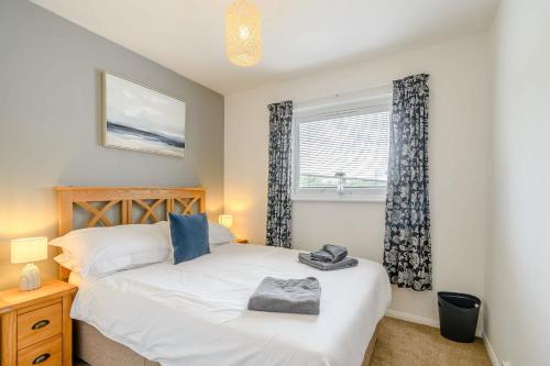 a bedroom with a bed and a window at Smugglers Rest in Milford Haven